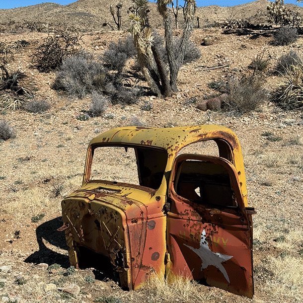 Rusted truck cab in the Joshua trees