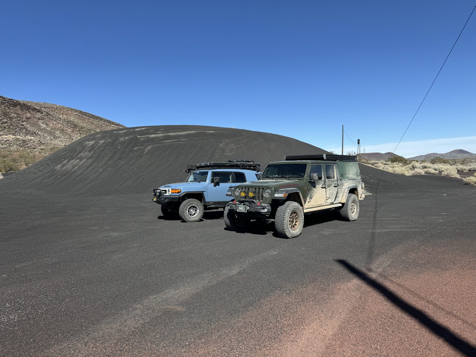 The FJ and the Gladiator on black cinder near the lava tubes