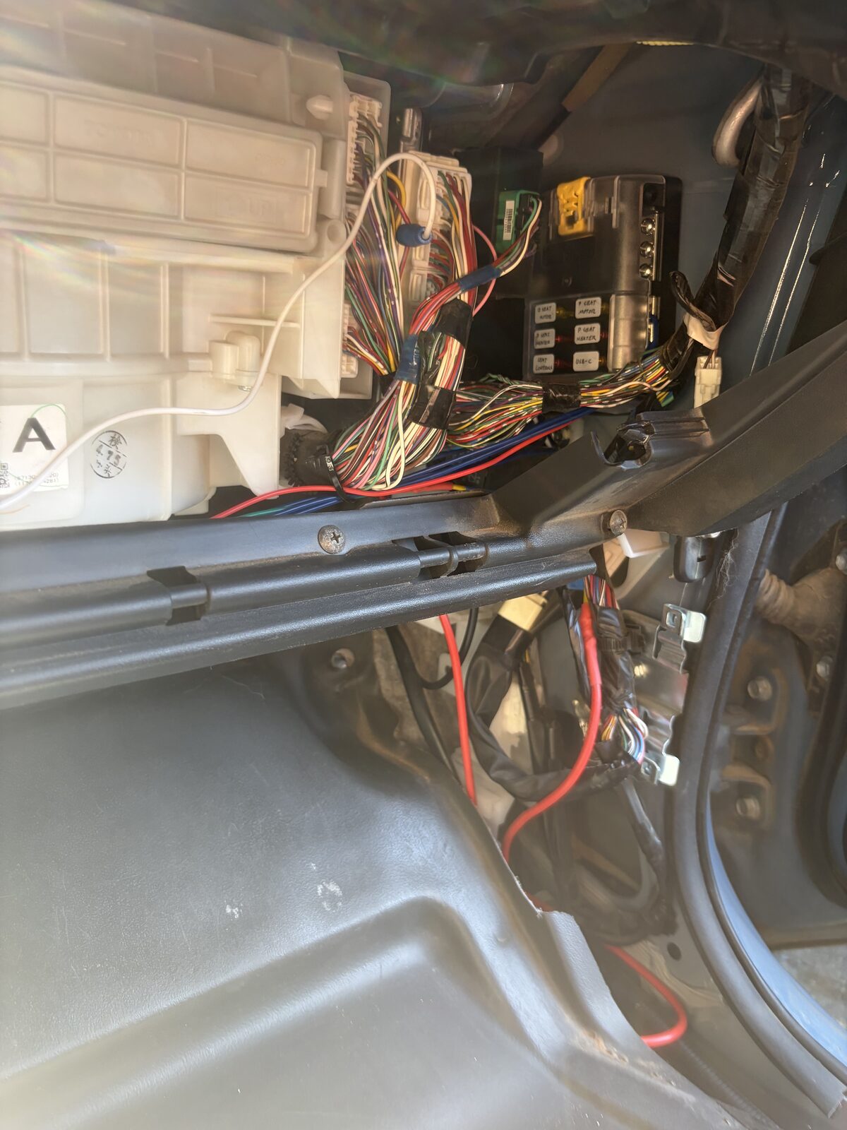 The Blue Sea fuse block mounted under the dash