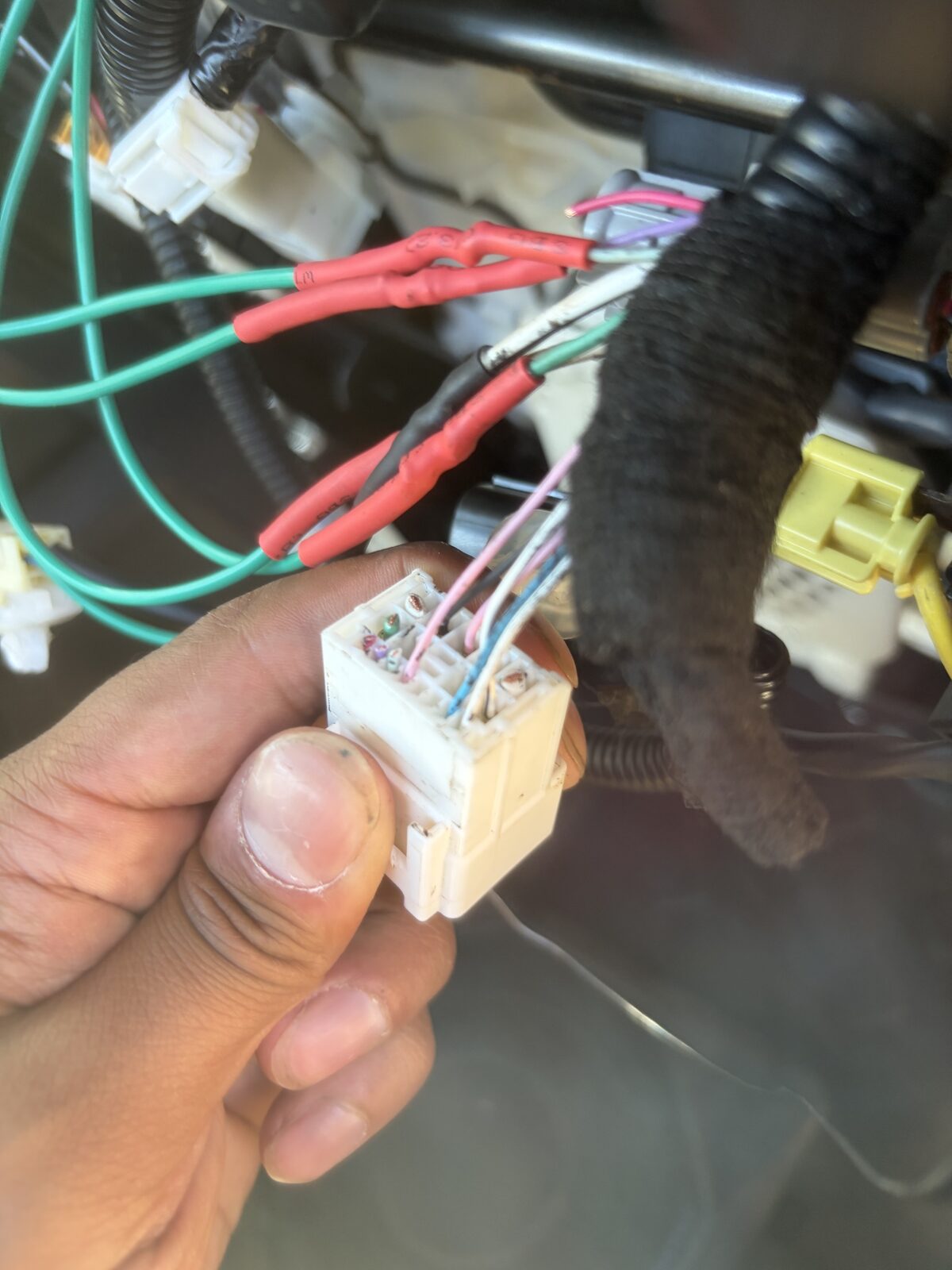 The GX seat connector in hand, rewired with crimped, heat-shrunk leads