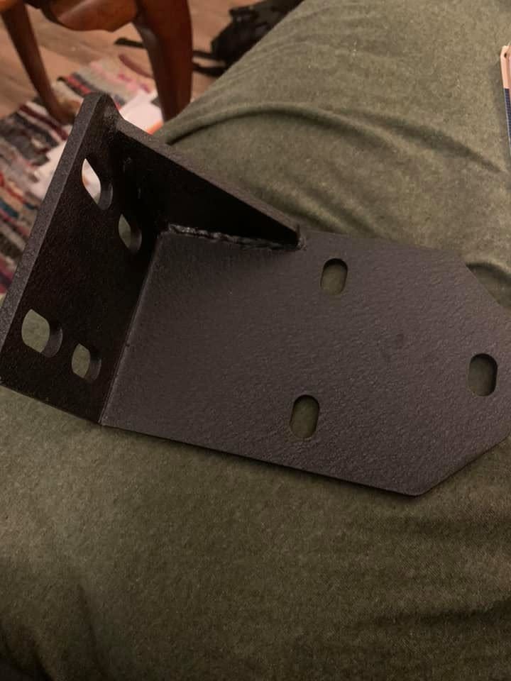 One of the EAG Jeep XJ bumper brackets, powder-coated black, with slotted bolt holes