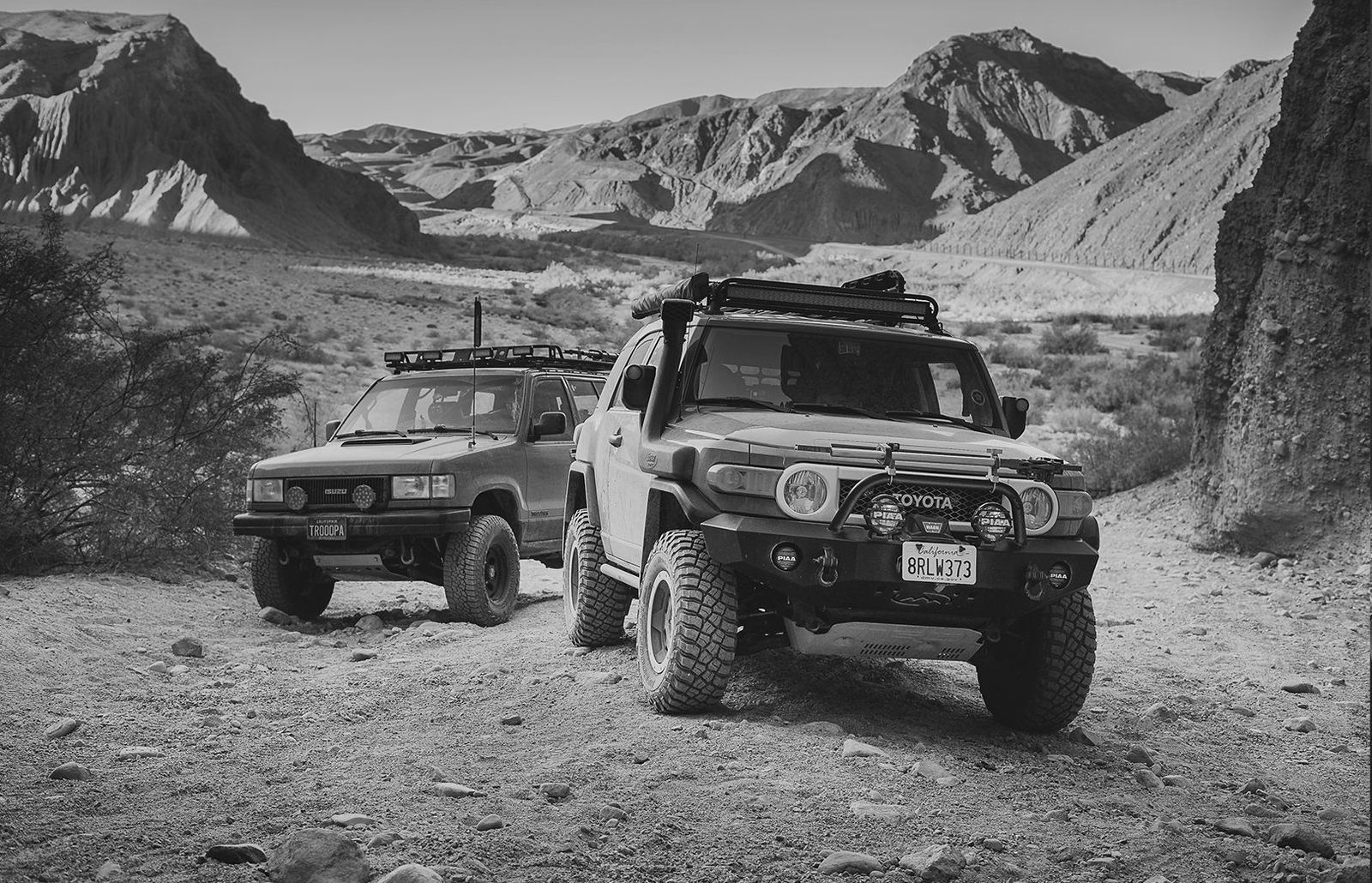FJ and 4Runner in a wash, black and white